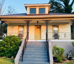 a house with a staircase leading to the front door at The Humble House in Martinsville
