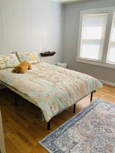 a dog laying on a bed in a bedroom at The Humble House in Martinsville