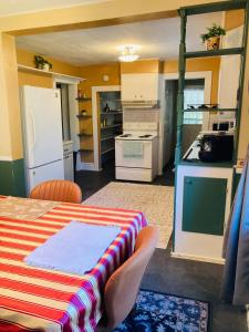 a small kitchen with a table and a refrigerator at The Humble House in Martinsville