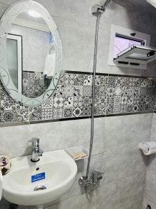 a bathroom with a sink and a mirror at Casa Inass blue in Chefchaouen +32 photos