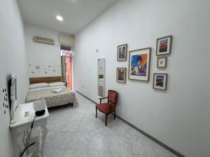 a room with a bed and a desk and a chair at B&B Napul'è in Naples