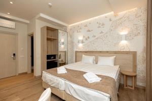 a bedroom with a large bed with towels on it at Leomare in Odesa +60 photos