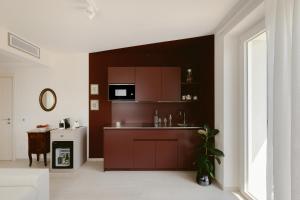 a kitchen with brown cabinets and a sink at Hortus Bellagio in Bellagio +64 photos
