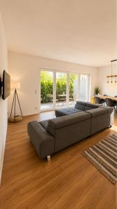 a large living room with a couch and a table at Allgäu Ferienhaus 5 Apartments mit Sauna,Balkon, Garten und Privatparkplatz in Blaichach