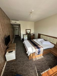 a hotel room with two beds and a television at CİTY HOME tüyap in Esenyurt