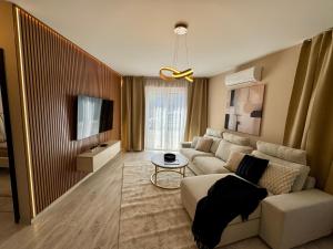 a living room with a couch and a tv at Ditta Home in Nyíregyháza