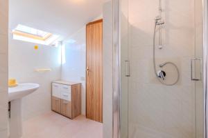 a bathroom with a shower and a sink at Family friendly apartment in Giba Center in Giba