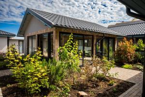 a house with a garden in front of it at VAMA 25- Vama Veche in Vama Veche