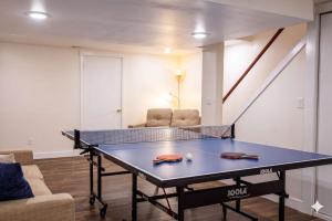 a ping pong table in a living room at Stunning Ranch in the woods in Berrien Springs