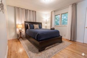 a bedroom with a bed with a blue comforter at Stunning Ranch in the woods in Berrien Springs