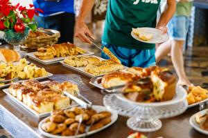 a table full of different types of food on plates at Cabanas do Morro in Serra Negra +131 photos