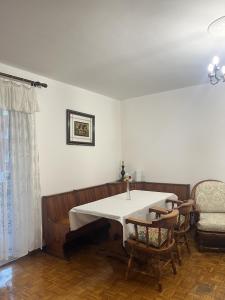 a dining room with a table and a chair at Sea & Books Studio in Trieste +3 photos