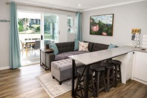 a kitchen and living room with a couch and a table at Die Fijnbos in Glentana