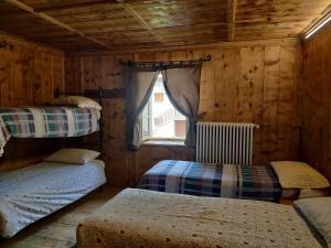 a bedroom with two bunk beds and a window at Locanda Teggiate in Madesimo +15 photos