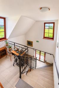 a dining room with a table and a staircase at Férovka in Jeseník