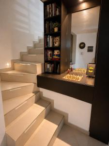 a room with stairs with a book shelf and a chessboard at Casa Di Manuelito in Monterrey