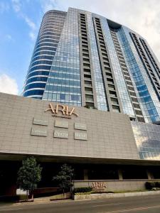 a large building with a x axis sign on it at 1 Bedroom Apartment in Aeon Towers I City Views I Free Wi-fi, Gym and Pool in Davao City
