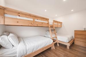 a bedroom with two bunk beds and a ladder at 206 Val-des-Neiges - MSA LUX in Beaupré