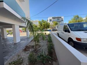 a white van parked next to a building with a palm tree at Olympus Hospitality Rhodes in Rhodes Town +15 photos