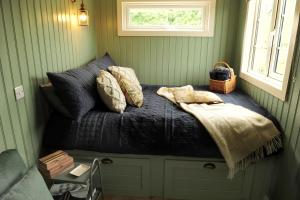 a bed in a room with a window and pillows at The Barraghan in Derrygonnelly