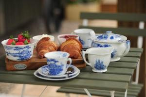 a table topped with cups and croissants and strawberries at The Barraghan in Derrygonnelly