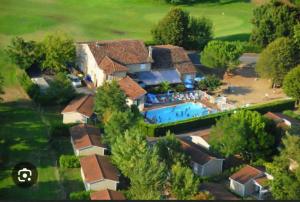 an aerial view of a house with a swimming pool at Chalet La Caz'à Joooh in Rivières +9 photos