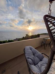 a balcony with a chair and a view of the ocean at Ionian Moon 1 in Preveza