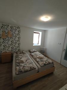 two beds in a small room with a window at 3 bedroom Apartman Izolana in Izola