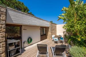 a wooden deck with chairs and a table at Villa Aster in Coti-Chiavari