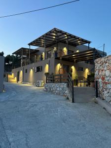 a building with a porch with lights on it at Elysian Studios in Mavrovouni
