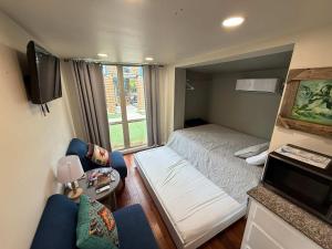 a small bedroom with a bed and a window at PPI Native American Theme suite in Medicine Park