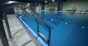 a swimming pool with a remote control on the side of it at RELAX-zepter in Vrnjačka Banja