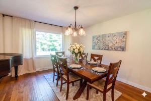 a dining room with a table and a piano at Stunning Ranch in the woods in Berrien Springs