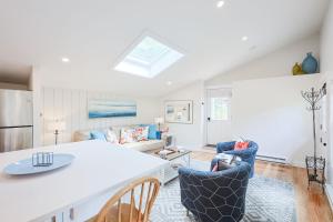 a kitchen and living room with a table and chairs at Granite Cottage in Rockport