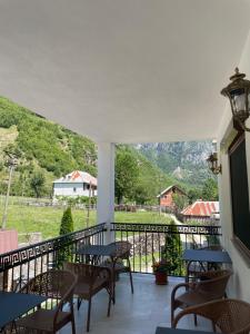 a balcony with tables and chairs and a view of a mountain at Dragobia House & Table in Dragobi