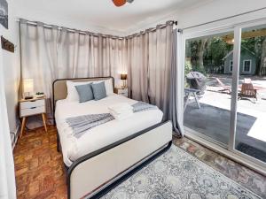 a bedroom with a bed and a large window at Island Retreat - Great for Large Groups in Charleston +82 photos