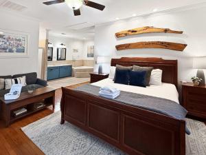 a bedroom with a large bed and a living room at Island Retreat - Great for Large Groups in Charleston
