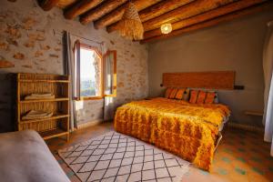 a bedroom with a bed in a room with a window at Bergerie Imsouane in Imsouane