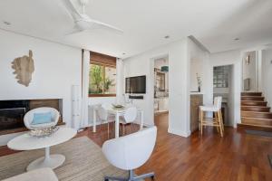 a white living room with a table and chairs at Villa Aster in Coti-Chiavari