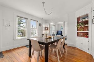 a dining room with a black table and chairs at Helena House in Gloucester