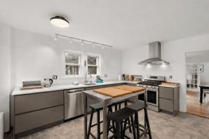 a kitchen with a counter and a stove top oven at Helena House in Gloucester