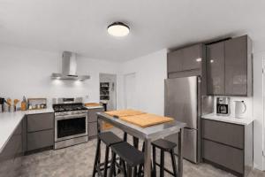 a kitchen with a table and some chairs in it at Helena House in Gloucester +21 photos