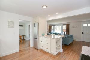 an open kitchen and living room with a blue couch at Just For the Halibut in Rockport +19 photos