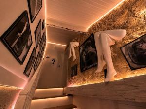 a mannequin standing on a staircase with pictures on the walls at Caporizon-Lov'BNB-La seule Love House de Dordogne in Biras