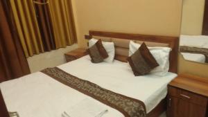 a bedroom with two beds and a mirror at guest house honey haldwani in Haldwāni