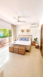 a bedroom with a large bed and a balcony at Blue Island Punta Rucia in Punta Rucia
