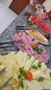 a table topped with plates of cheese and meats at Hotel CANTO DA SERRA in Caldas Novas
