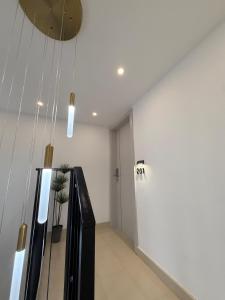 a hallway with a white wall and a door at The Elysium Rooms in Makarska