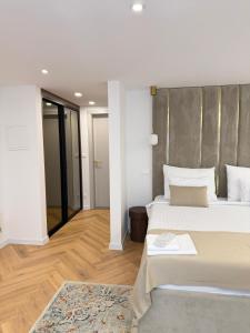 a large bedroom with two beds and a rug at The Elysium Rooms in Makarska