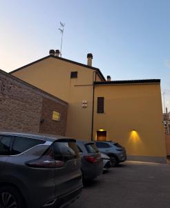 two cars parked in a parking lot next to a building at Da Nella 2 in Ancona